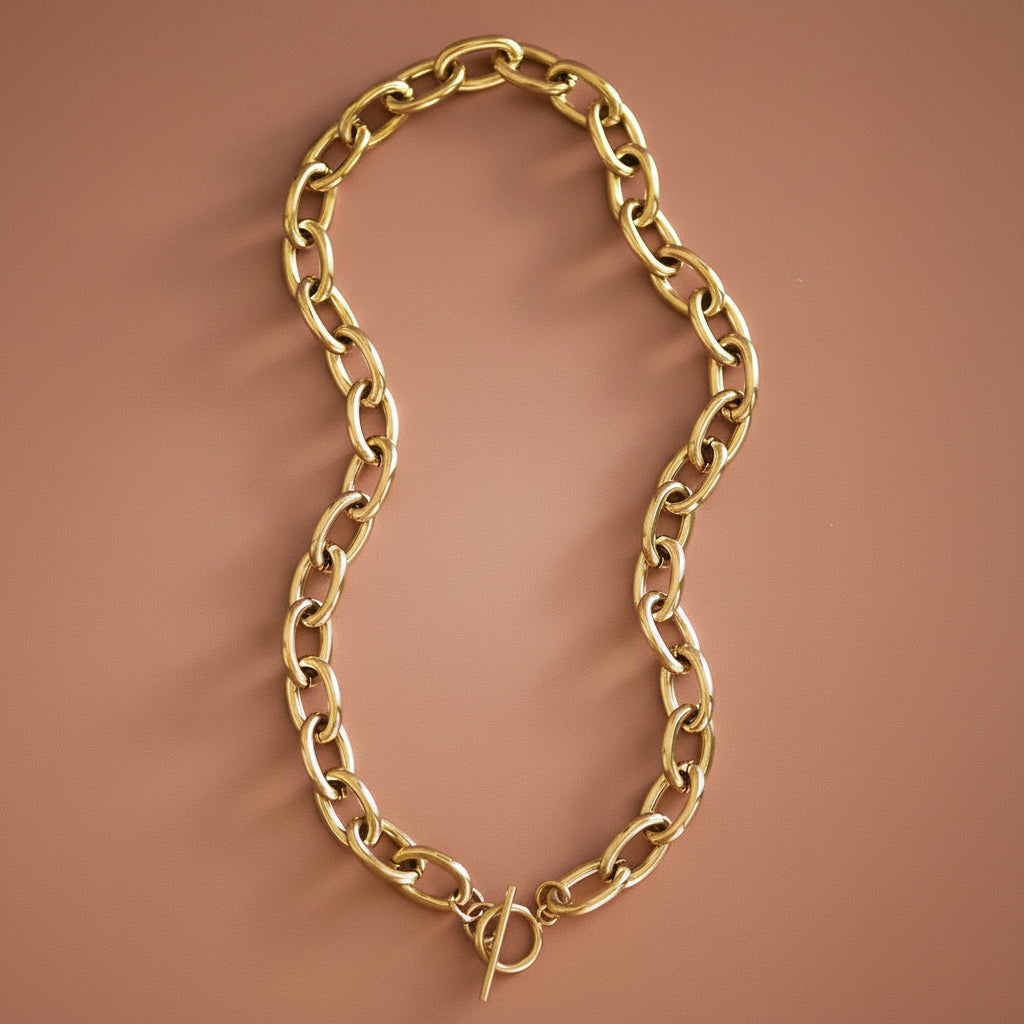 Elevate your everyday style with this 18K gold plated stainless steel chain necklace. Measuring approximately 18 inches, this chunky oval link design offers a bold yet versatile look that works with any outfit. Crafted for durability, this necklace is hypoallergenic, waterproof, and sweatproof—perfect for wearing through your day without worry. The tarnish-resistant finish keeps your gold plating looking radiant longer.