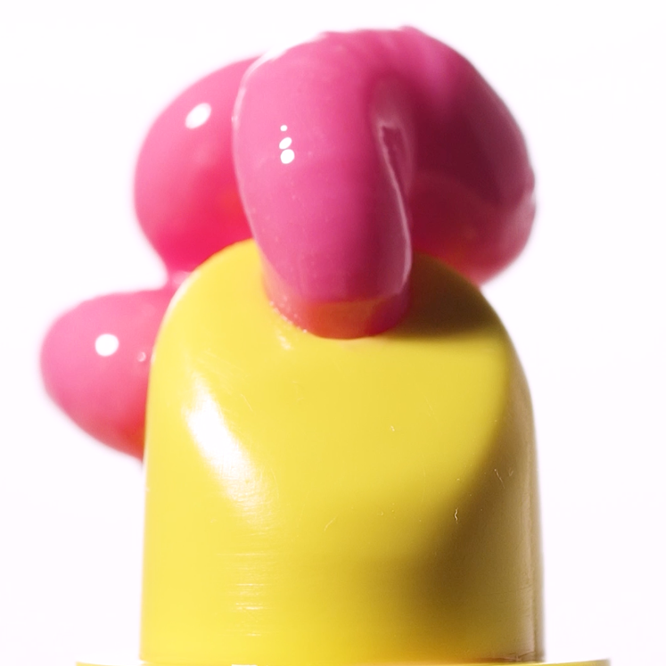Yellow and pink plastic object on a white background