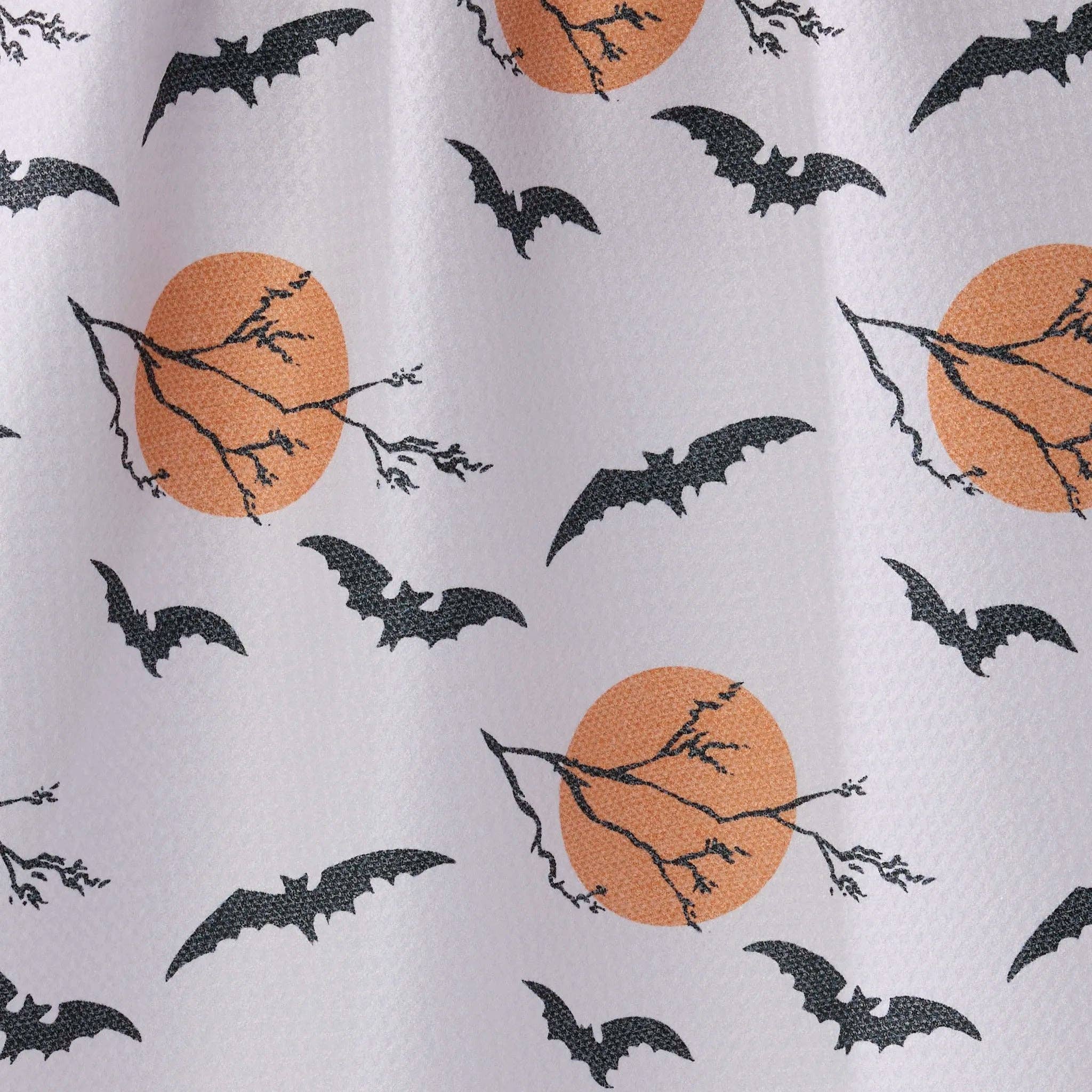 White TEA TOWEL with a repeating Halloween pattern featuring black bats, bare tree branches, and orange full moons.