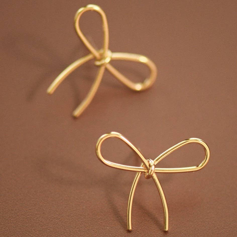 Elevate your everyday style with these charming gold bow knot stud earrings. Crafted from delicate wire in a warm gold tone, these petite studs measure approximately 0.9" x 0.8" and feature a classic bowknot design that adds a touch of feminine elegance. Perfect for layering or wearing solo, these versatile earrings transition seamlessly from casual to dressy occasions. The lightweight construction ensures all-day comfort, making them an ideal choice for those who love timeless, understated accessories.