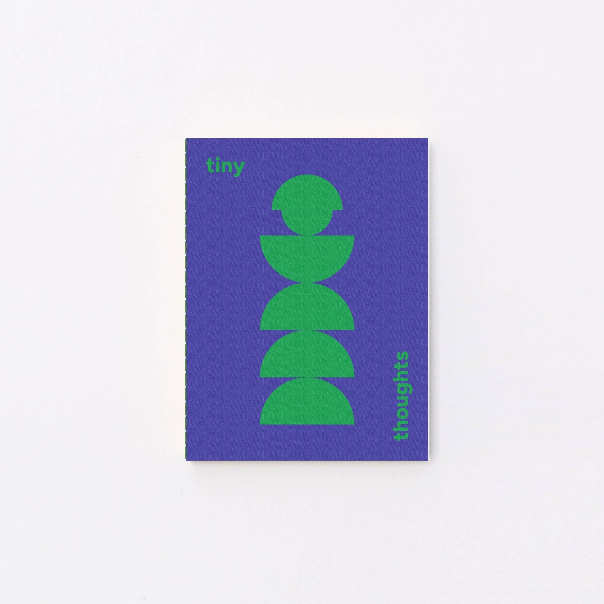 A minimalist tiny notebook cover featuring a purple background with a green stacked semicircle graphic and green text saying tiny thoughts, displayed against a clean white background.