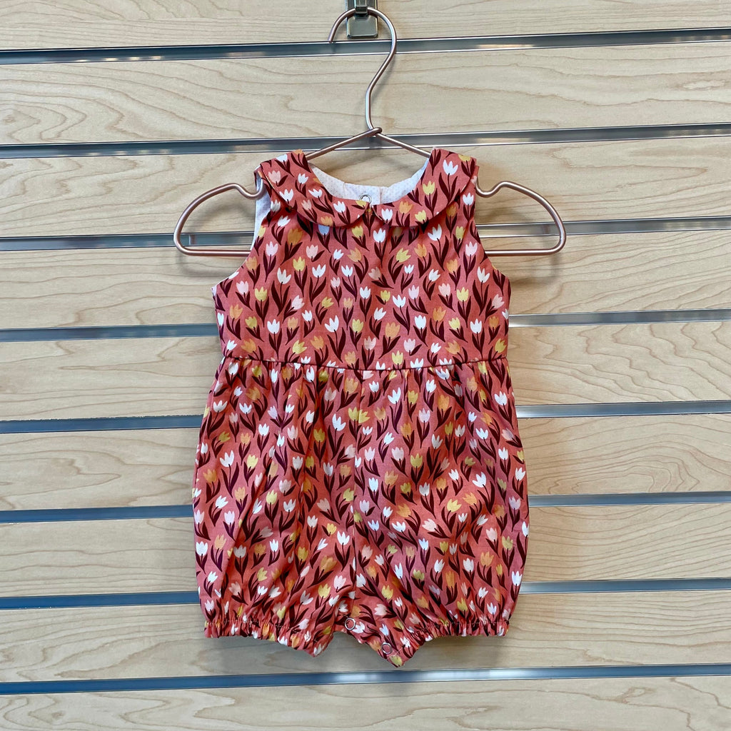 Welcome the warmer season with The Harper Romper - Pink Tulips! Featuring a beautiful pink tulip pattern, this romper will make your little one the most stylish kid on the block! With its comfortable fabric and adjustable straps, they'll be able to "romp" around in style and stay cool even on the hottest days! The perfect addition to your adorable baby’s wardrobe!