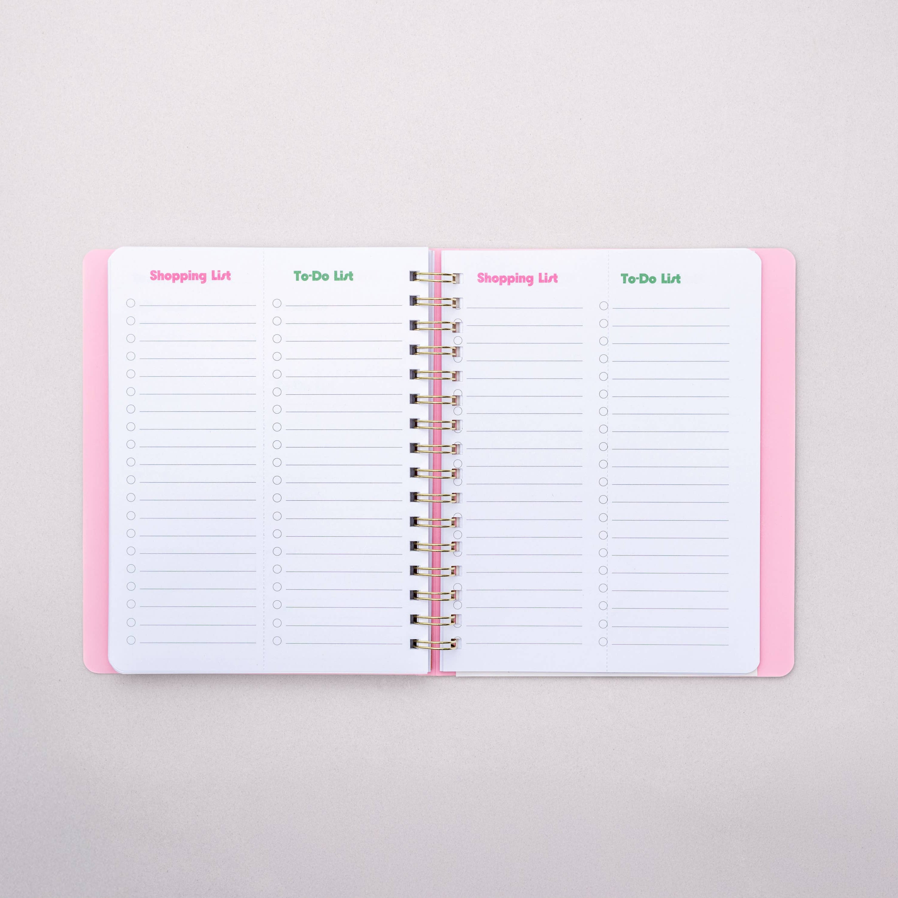 Open notebook with lined pages on a light gray background