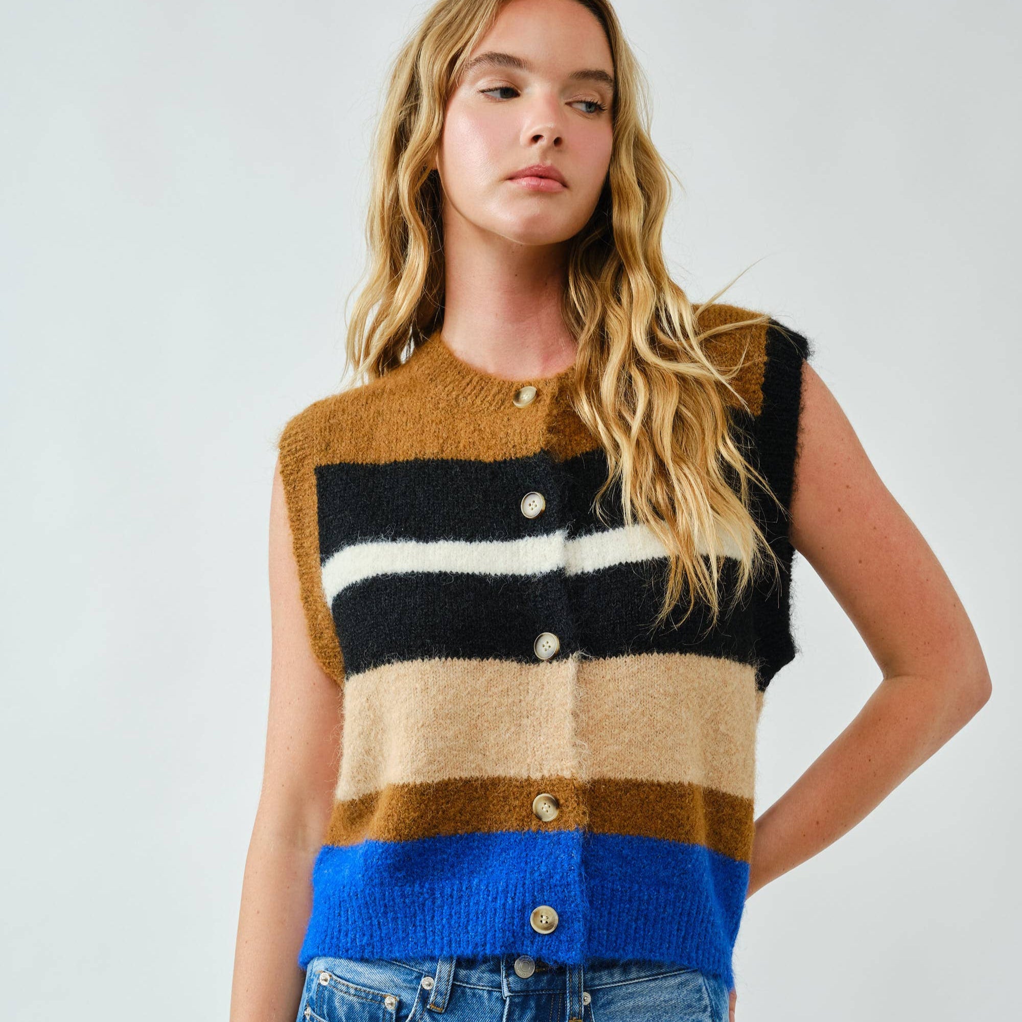 Cozy up in bold style with this soft pullover sweater vest, designed with striking multicolor stripes. The fuzzy knit texture adds warmth, while the relaxed fit and button-down front offer a laid-back, vintage-inspired feel. Whether layered over a shirt or worn on its own, this vest delivers both comfort and standout personality.
