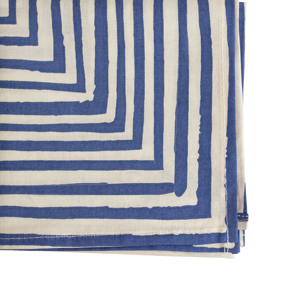 Folded fabric with blue and white striped pattern on a white background