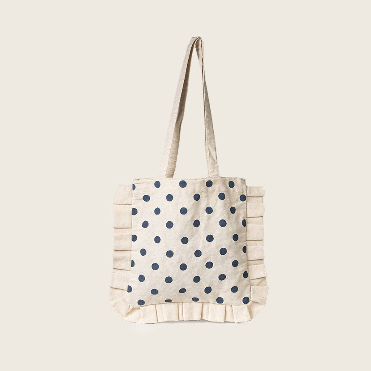 Tote bag with blue polka dots on a beige background