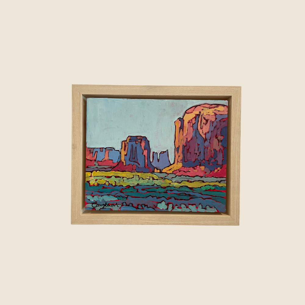 Landscape mixed media painting of Monument Valley, with cool blue sky, warm reds of the sandstone buttes, dark purple shadows accentuate the height of the towering buttes, cool greens and blues represent the sage brush in the foreground.