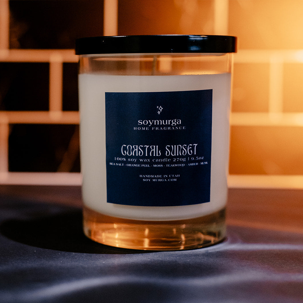 9.5 oz Coastal Sunset soy candle in a clear glass container.