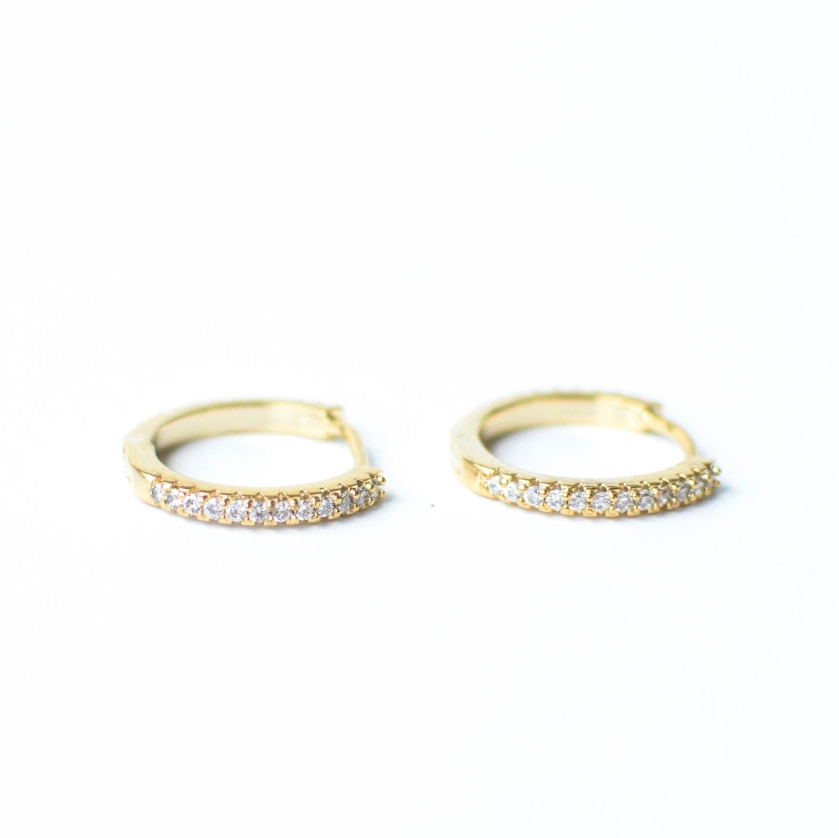 gold huggie with diamonds along side.