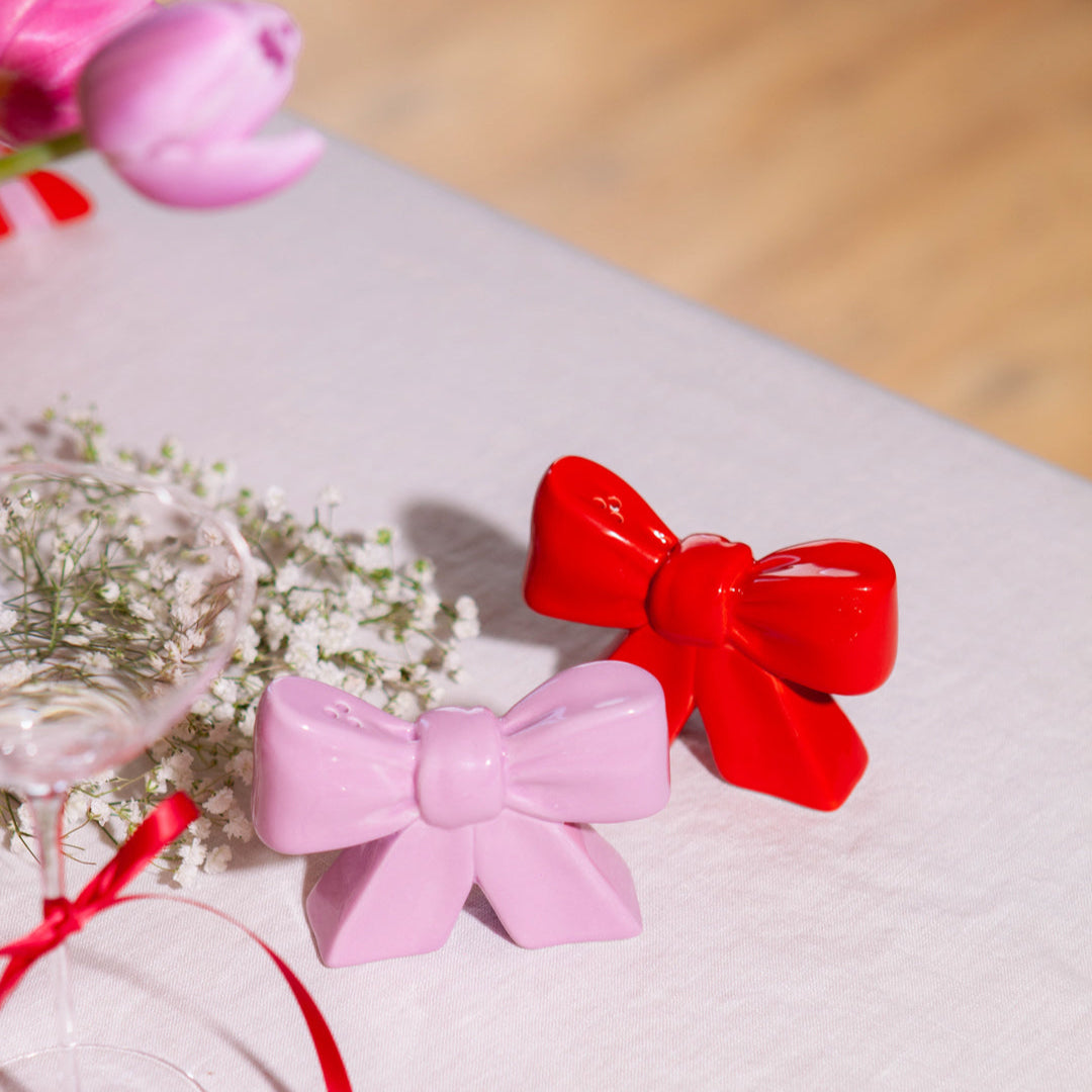 Ceramic salt and pepper shakers shaped as bows, taking inspiration from the ethereal ballet world and the whimsical allure of coquetry.