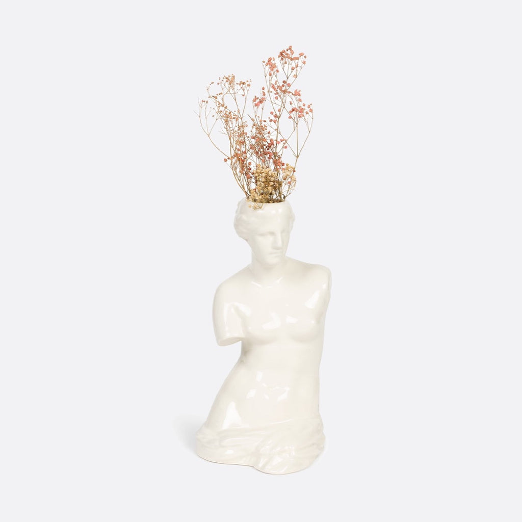 Ceramic vase shaped as Venus Goddess."Embrace your inner goddess with the Venus Vase, a ceramic masterpiece in the shape of the iconic Venus Goddess. Adorn your space with this unique and beautiful vase, bringing a touch of elegance and charm to any room. Perfect for displaying fresh flowers or standing alone as a work of art. (Flowers not included)."