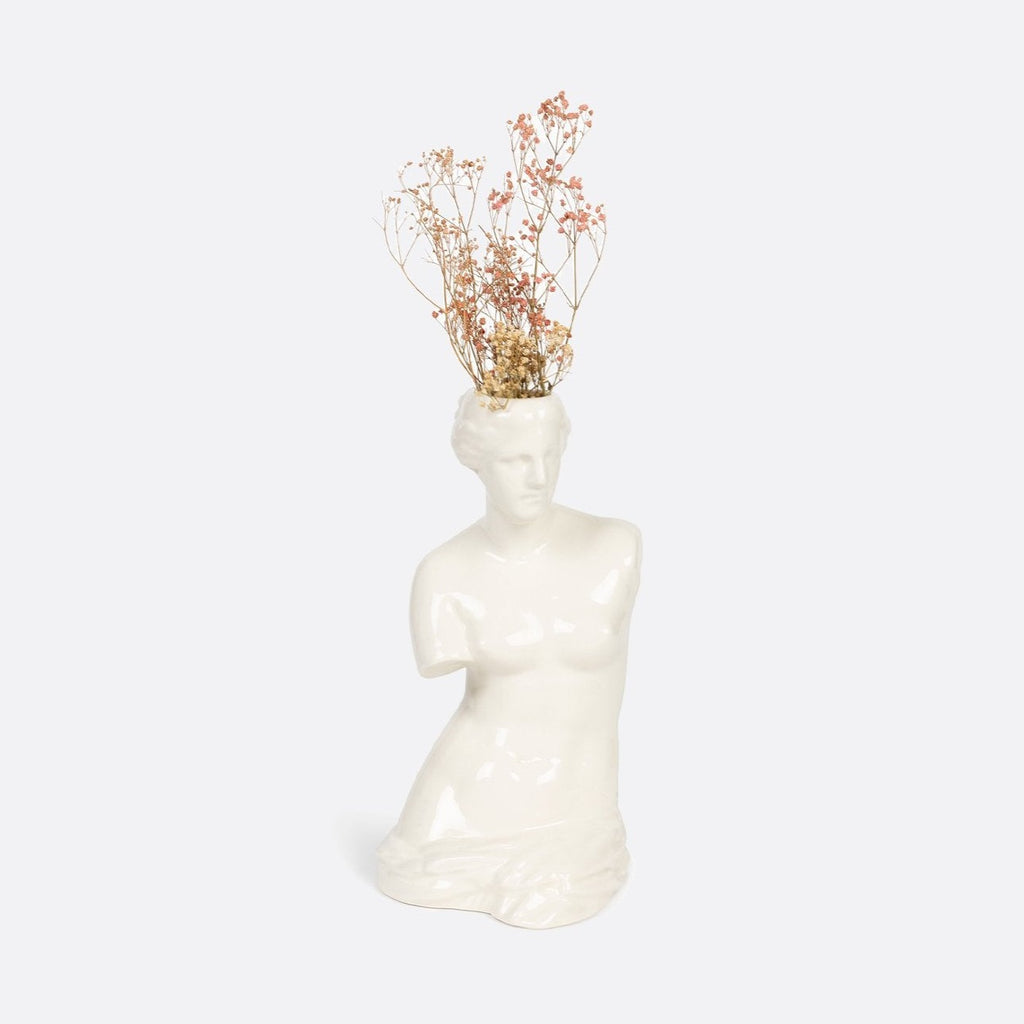"Embrace your inner goddess with the Venus Vase, a ceramic masterpiece in the shape of the iconic Venus Goddess. Adorn your space with this unique and beautiful vase, bringing a touch of elegance and charm to any room. Perfect for displaying fresh flowers or standing alone as a work of art. (Flowers not included)."