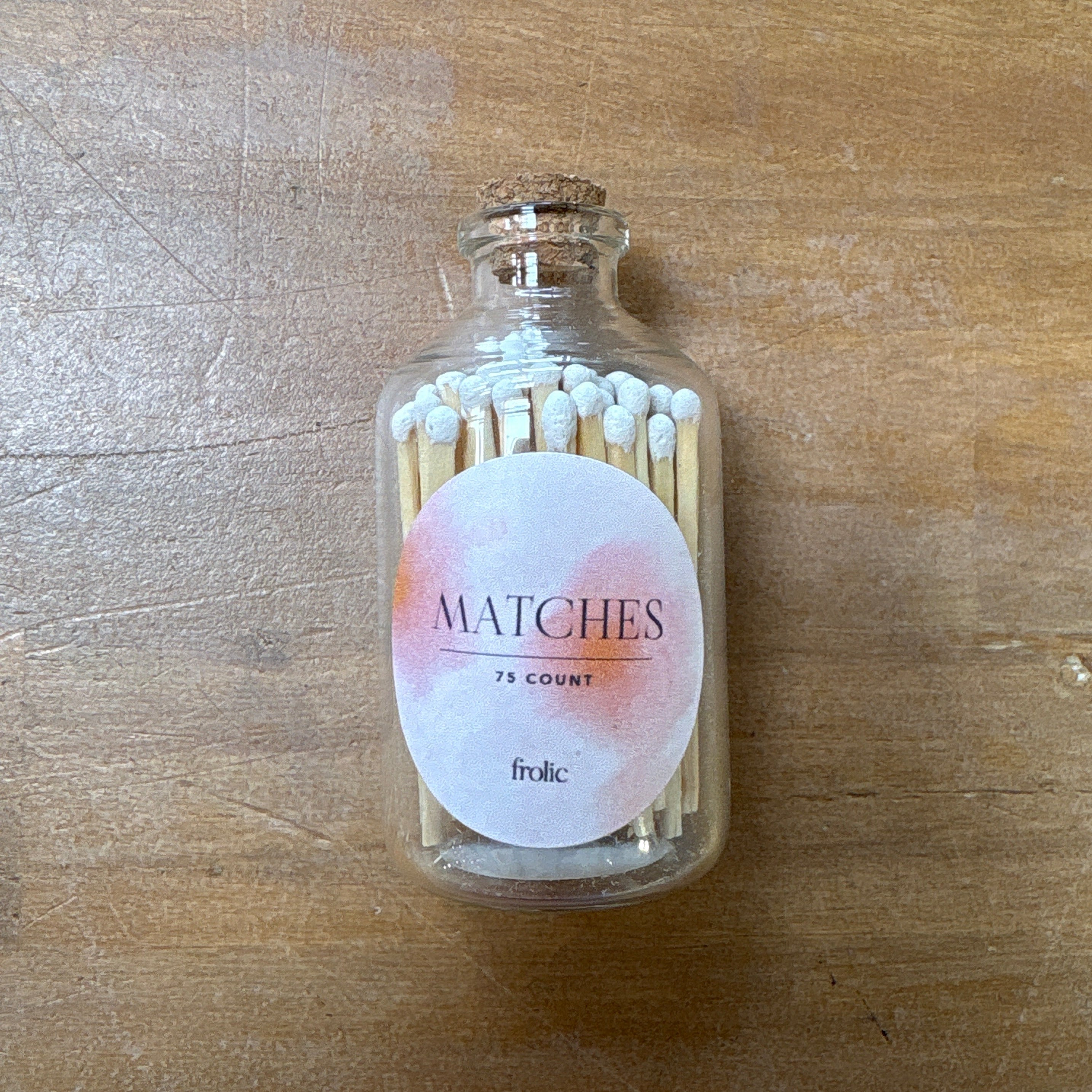 Glass bottle with matches on a wooden surface