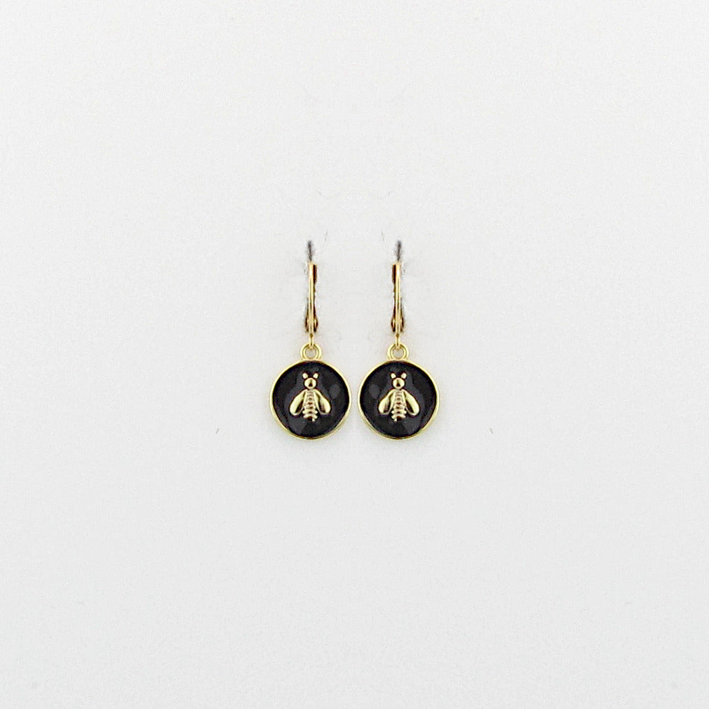 Unveil your love for classic designs with our Bria Bee Earring. This delightful piece from La Vie Parisienne features an enchanting enamel earring with a gold bee at its center. Crafted following traditional French artisan techniques, the earring beautifully exhibits the delicate details of historic designs. Handmade and hand-set with Swarovski crystals, it is a perfect blend of classic European findings and historical American pieces. A timeless piece.