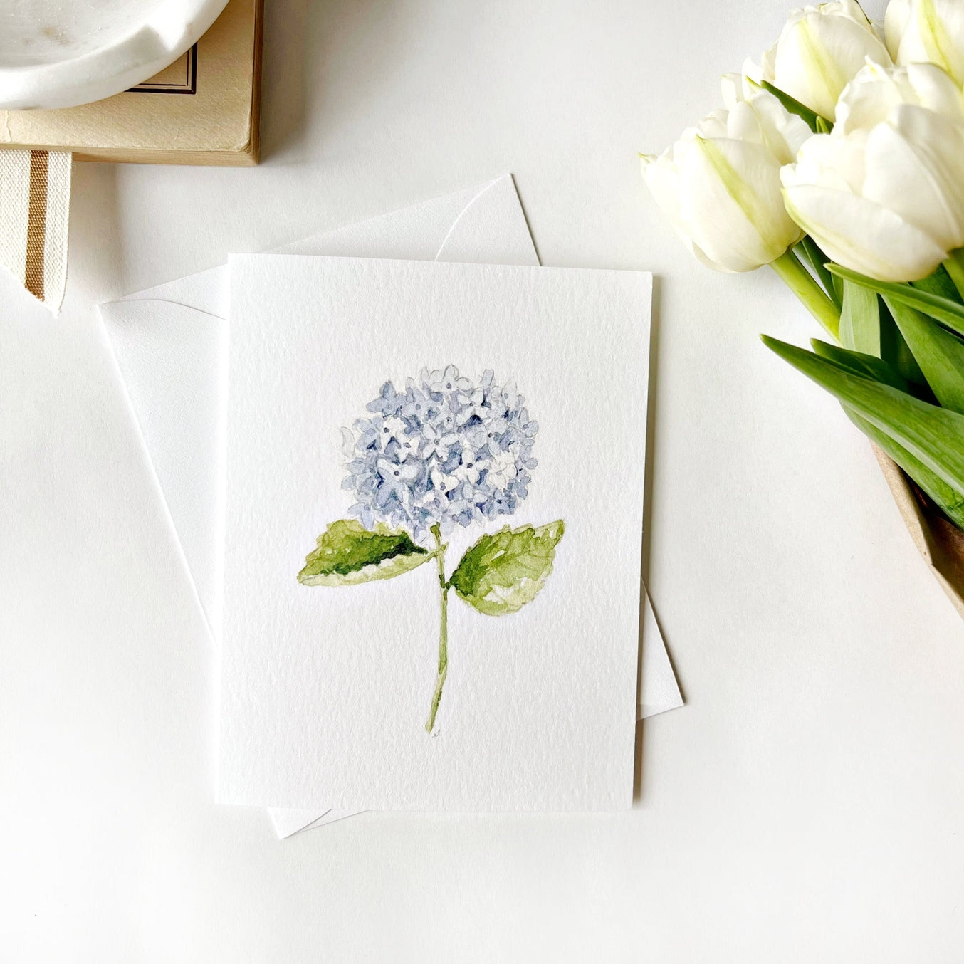 Send sweet greetings to your loved ones. The hydrangea stem notecards are blank on the inside with charming watercolor illustration on the front. They bring a touch of beauty to your thank-you notes, housewarming gifts, get-well wishes, and more.