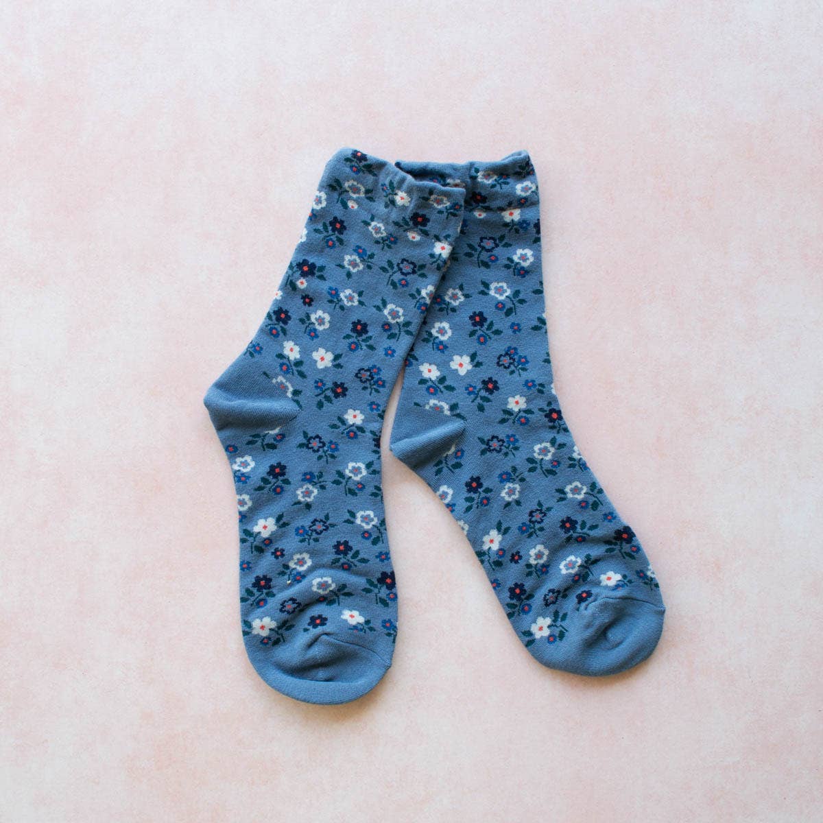These Garden Flower Socks will add a touch of whimsy to your outfit with their blue floral pattern. Made in a comfortable crew style, these socks will keep your feet cozy and stylish all day long. Perfect for the nature-lover or fashion-forward individual!