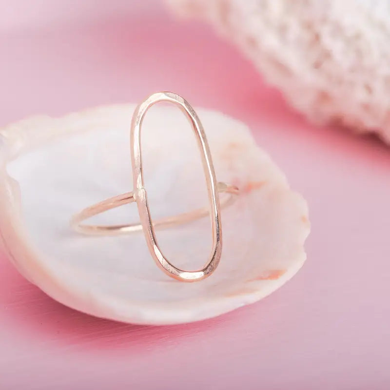 A open oval adorns the center of this statement ring, meant to be worn everyday. Made by hand one at a time out of goldfill wire, making it a perfect choice for daily wear. 16 gauge wire thickness. Polished finish.