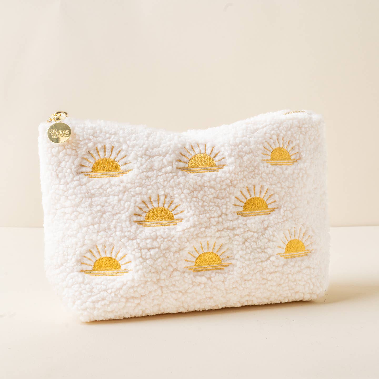 Add a cozy touch to your essentials with our rectangle teddy pouches. Crafted from soft sherpa fabric, these pouches feature a wipeable lining for easy cleaning and gold zippers and hardware for a polished look. The interior is lined with a fun printed fabric, making it as stylish on the inside as it is on the outside. The large rectangle size is perfect for keeping your items organized, and it pairs beautifully with our square or circle options.