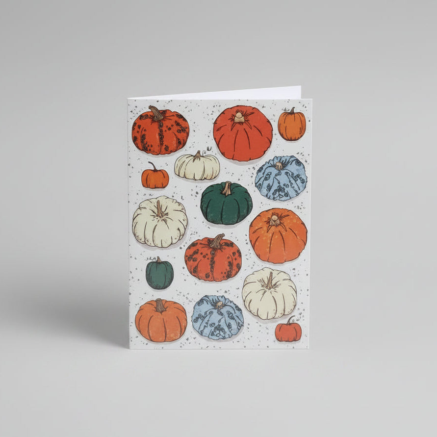Cream card with orange envelope. Design has lots of pumpkins in various colors (orange, green and cream) and lots of different illustrated textures.