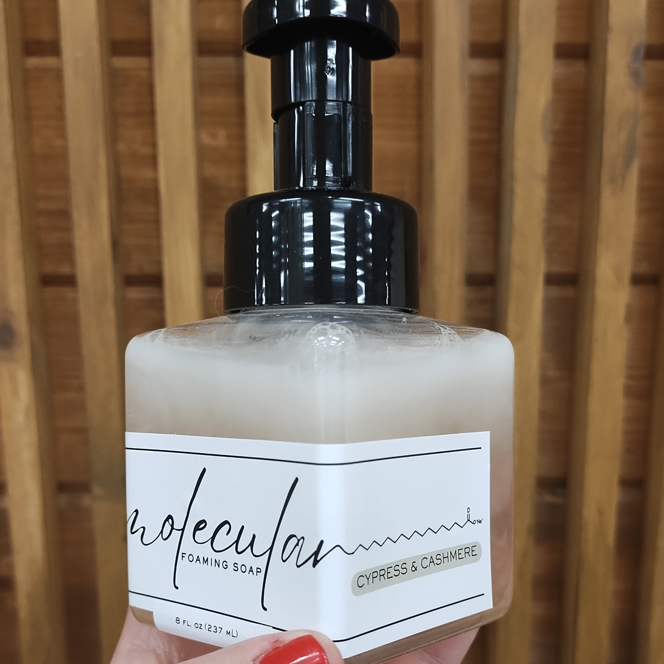 square clear bottle with black soap pump and white minimalistic label.