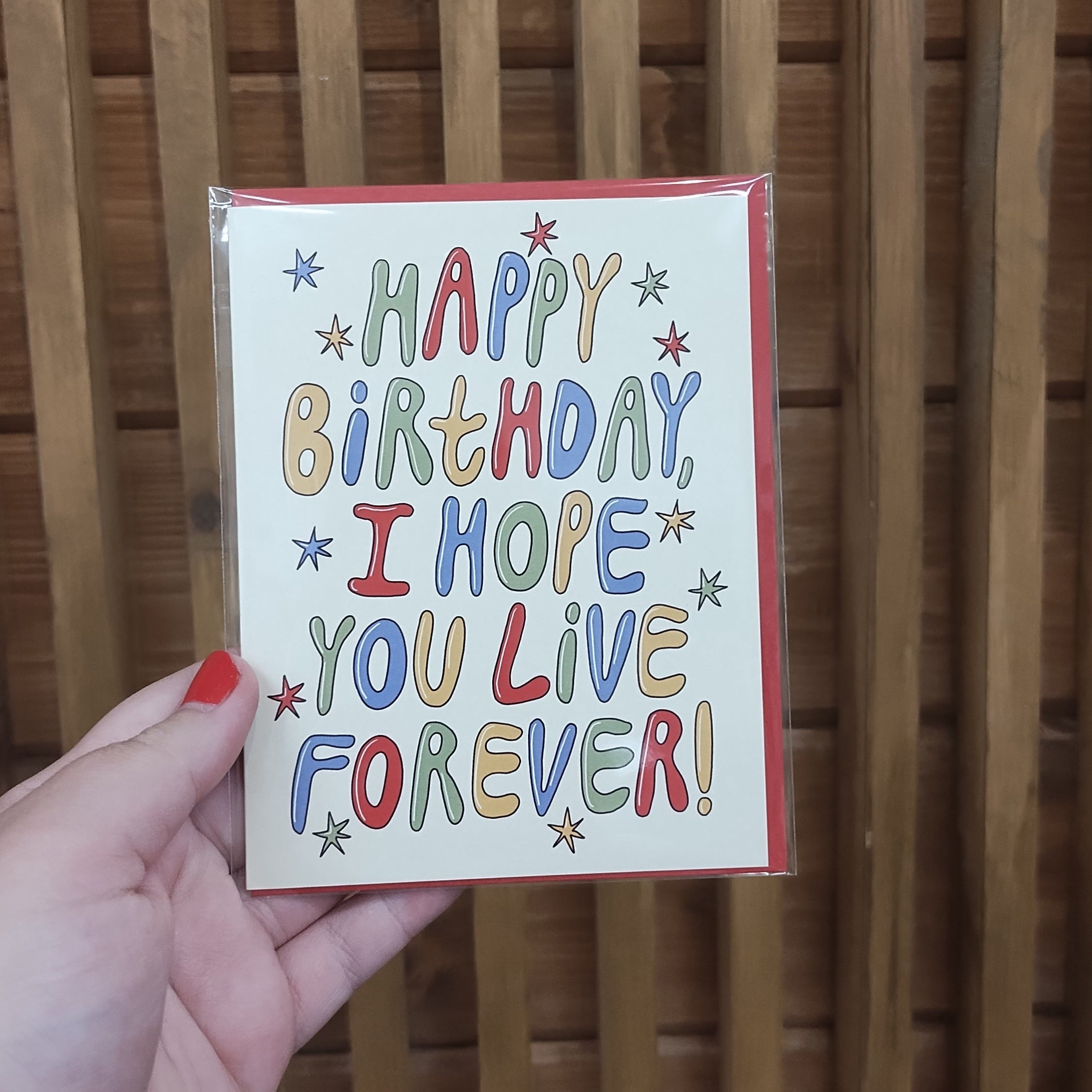 Cream card with colorful words and sparkles.