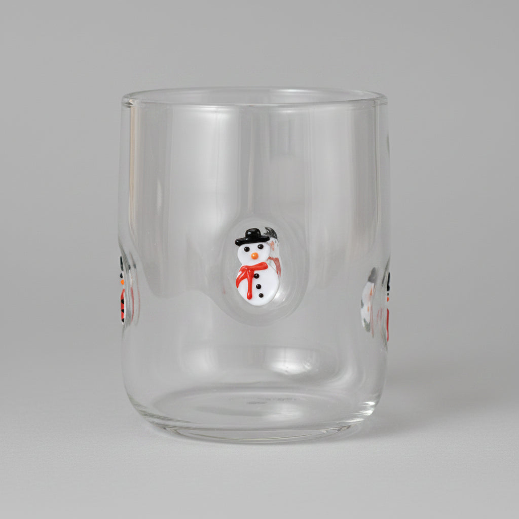 Clear glass tumbler with a snowman design on a white background