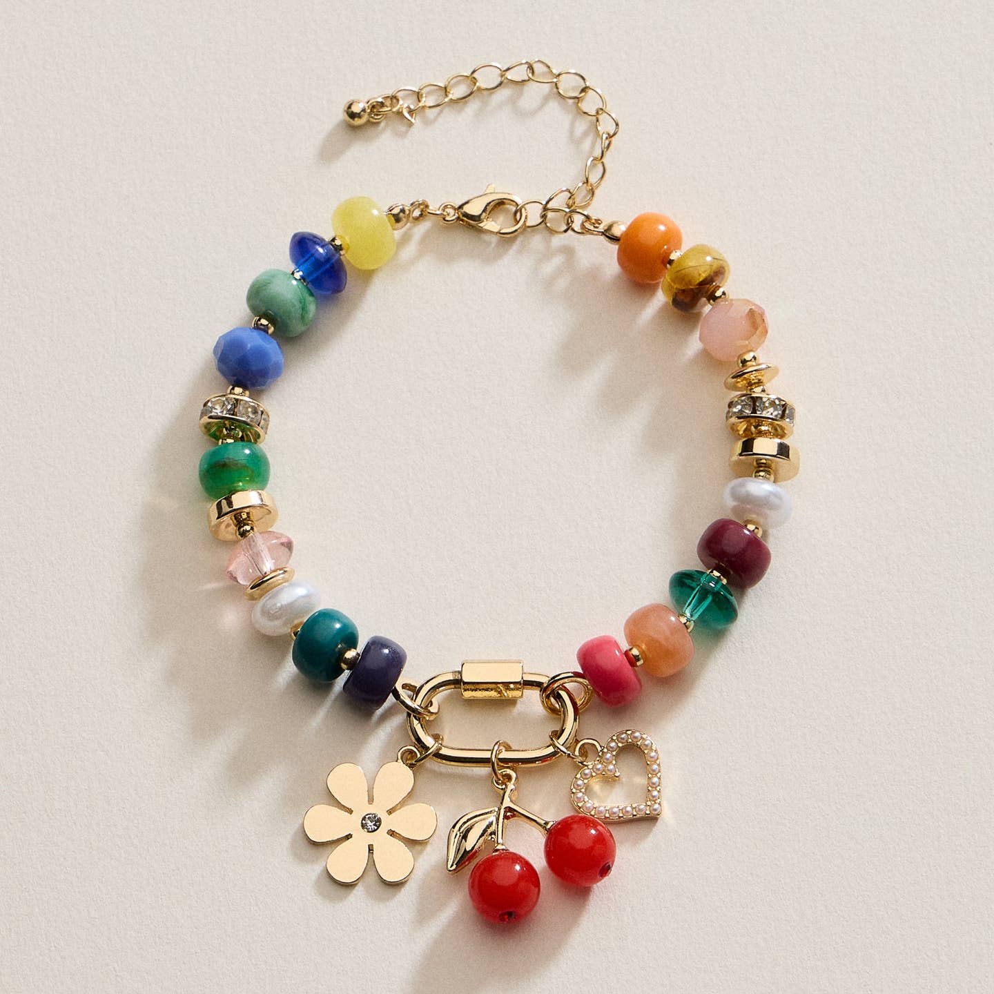 This thoughtfully designed bracelet features a curated mix of colorful beads, enhanced by three polished gold-tone charm accents. The blend of vivid tones and refined metallic details offers a modern yet understated aesthetic. Lightweight and comfortable, it pairs well with both day and evening looks, making it a versatile addition to any jewelry collection.