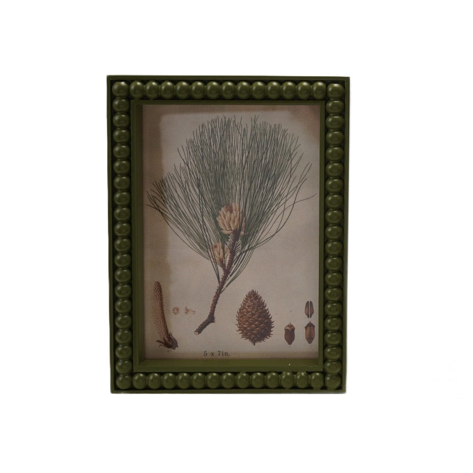 This Wood Hobnail Green Photo Frame beautifully showcases your 5x7 photos with its classic green finish and charming hobnail texture. Featuring a serene winter greens print inside, it adds warmth and seasonal elegance to any space while protecting your cherished memories. Perfect for displaying your favorite moments with a touch of timeless style.
Details:
Holds 5" x 7" Photo
Dimensions: 5.9” x 8”