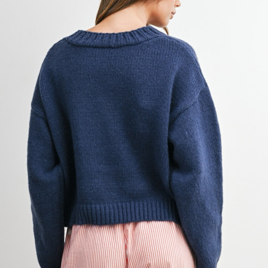 Add a touch of charm to your look with this Heart Pattern V-Neck Cropped Cardigan Top. Featuring a soft knit fabric, cute heart prints, and a flattering cropped fit, it's perfect for layering or wearing on its own. The button-down front and V-neckline offer a classic touch, making it a sweet and stylish choice for any casual outfit.