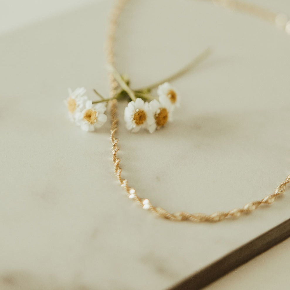 The Amelia Gold Filled Twist Necklace is the perfect piece to stack with other necklaces or wear as a stand alone accessory. She’s 18k gold filled, tarnish and wear resistant, and made to last. Hypoallergenic and nickel free, this unique and dainty 3mm chain is the perfect accessory all year long. 16" length.