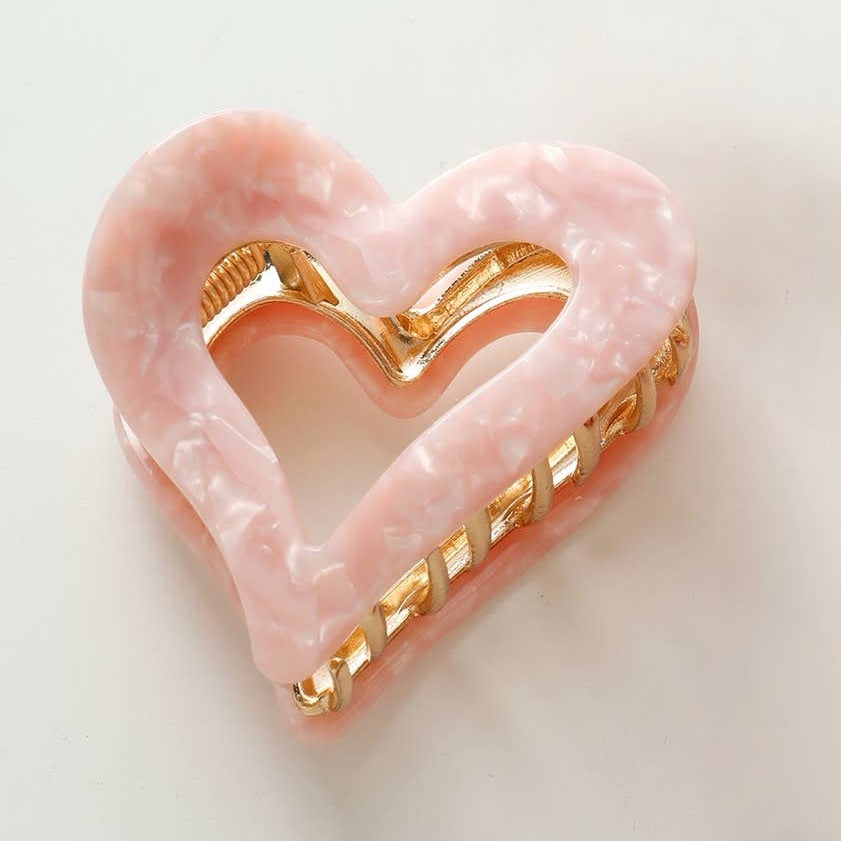 Capture your hair in style with this charming heart-shaped metal claw clip. Perfect for Valentine's Day or everyday wear, this saltwater pink accessory combines a playful design with reliable hold. The sturdy metal construction keeps your hair secure without slipping, while the romantic heart silhouette adds a touch of sweetness to any look. Whether you're styling an updo, half-up style, or securing a ponytail, this versatile clip is your go-to accessory for effortless elegance.
Details:
Small (2.4 inch)