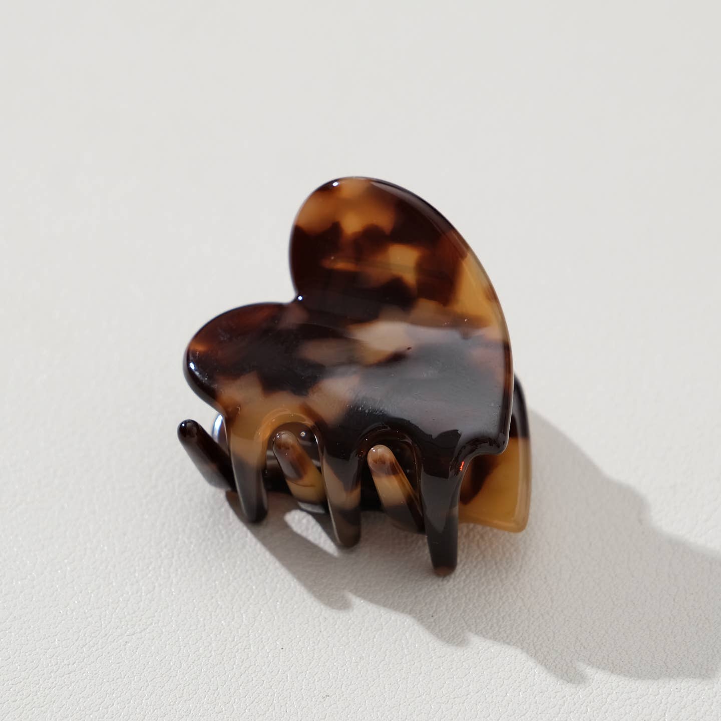 Adorable and functional, this mini heart claw clip brings a soft pop of deep tortoise charm to any hairstyle. Perfect for securing small sections of hair or adding a sweet accent to your look, this petite clip combines playful design with reliable hold. Whether you're styling for everyday wear or special occasions, this heart-shaped accessory is a delightful way to express your personal style while keeping hair in place.
Details:
Small (1.7 inch)
Materials: Cellulose Acetate