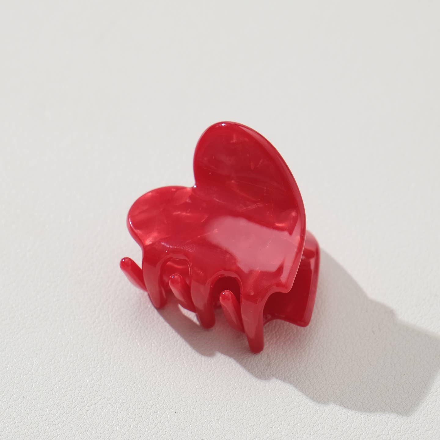 Adorable and functional, this mini heart claw clip brings a pop of cherry red charm to any hairstyle. Perfect for securing small sections of hair or adding a sweet accent to your look, this petite clip combines playful design with reliable hold. Whether you're styling for everyday wear or special occasions, this heart-shaped accessory is a delightful way to express your personal style while keeping hair in place.
Details:
Small (1.7 inch)
Materials: Cellulose Acetate