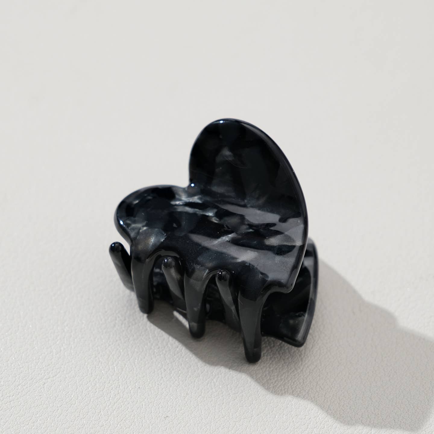 Adorable and functional, this mini heart claw clip brings dark onyx charm to any hairstyle. Perfect for securing small sections of hair or adding a sweet accent to your look, this petite clip combines playful design with reliable hold. Whether you're styling for everyday wear or special occasions, this heart-shaped accessory is a delightful way to express your personal style while keeping hair in place.
Details:
Small (1.7 inch)
Materials: Cellulose Acetate