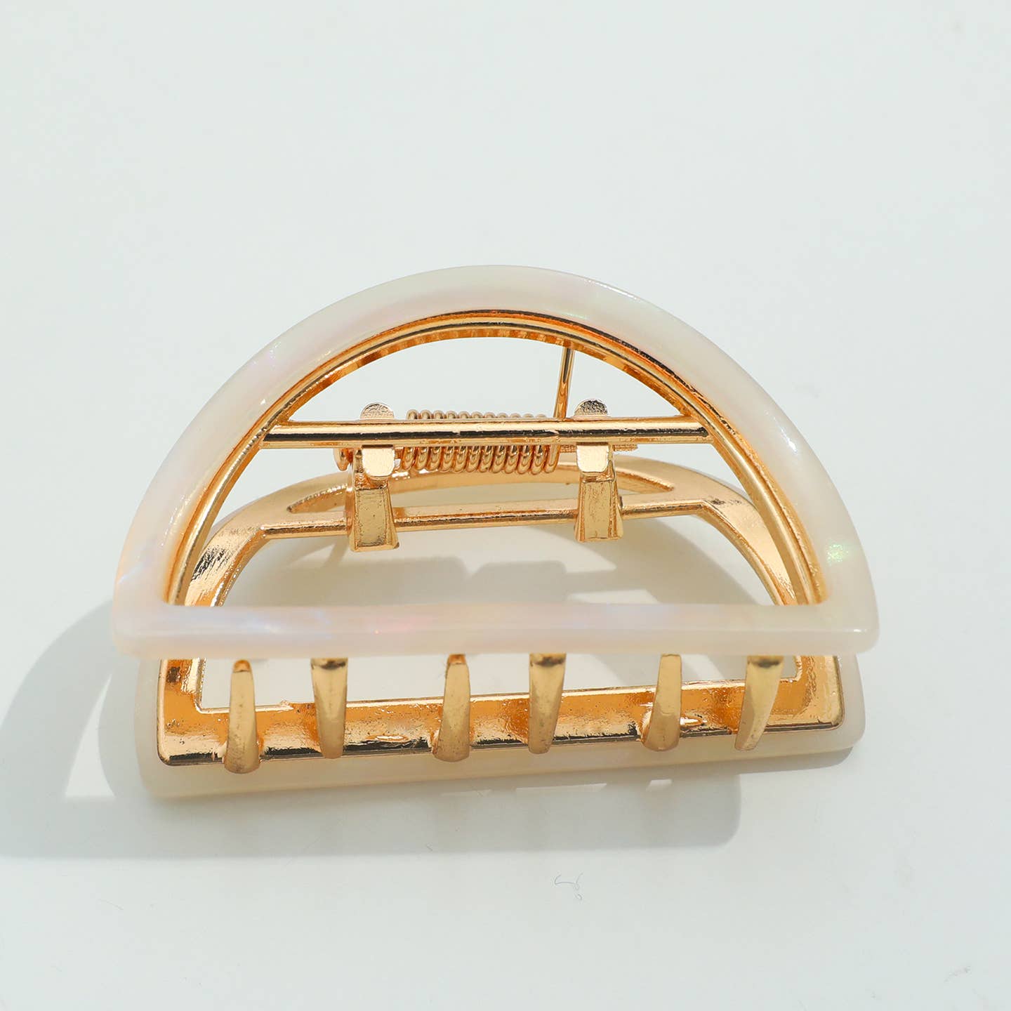 Elevate your hair game with this stunning half moon claw clip in soft opal. Featuring a durable metal claw mechanism, it delivers a secure grip that holds all day without slipping or snagging. The elegant crescent shape flatters any hair type and works beautifully for casual updos, half-up styles, or securing thick sections with ease. A versatile accessory that combines timeless design with dependable performance.
Details:
Small (2 inch)