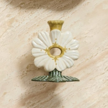 Bloom where you glow! The Soft Petal Candleholder is a delightful twist on floral elegance. Shaped like a blossoming white flower, this charming candleholder cradles your candle in botanical bliss. Perfect for adding a pop of flora and personality to your nightstand, bookshelf, or table, it transforms ordinary candlelight into something magical. Let this playful piece bring a garden-fresh vibe and warm, flickering ambiance to any room in your home.