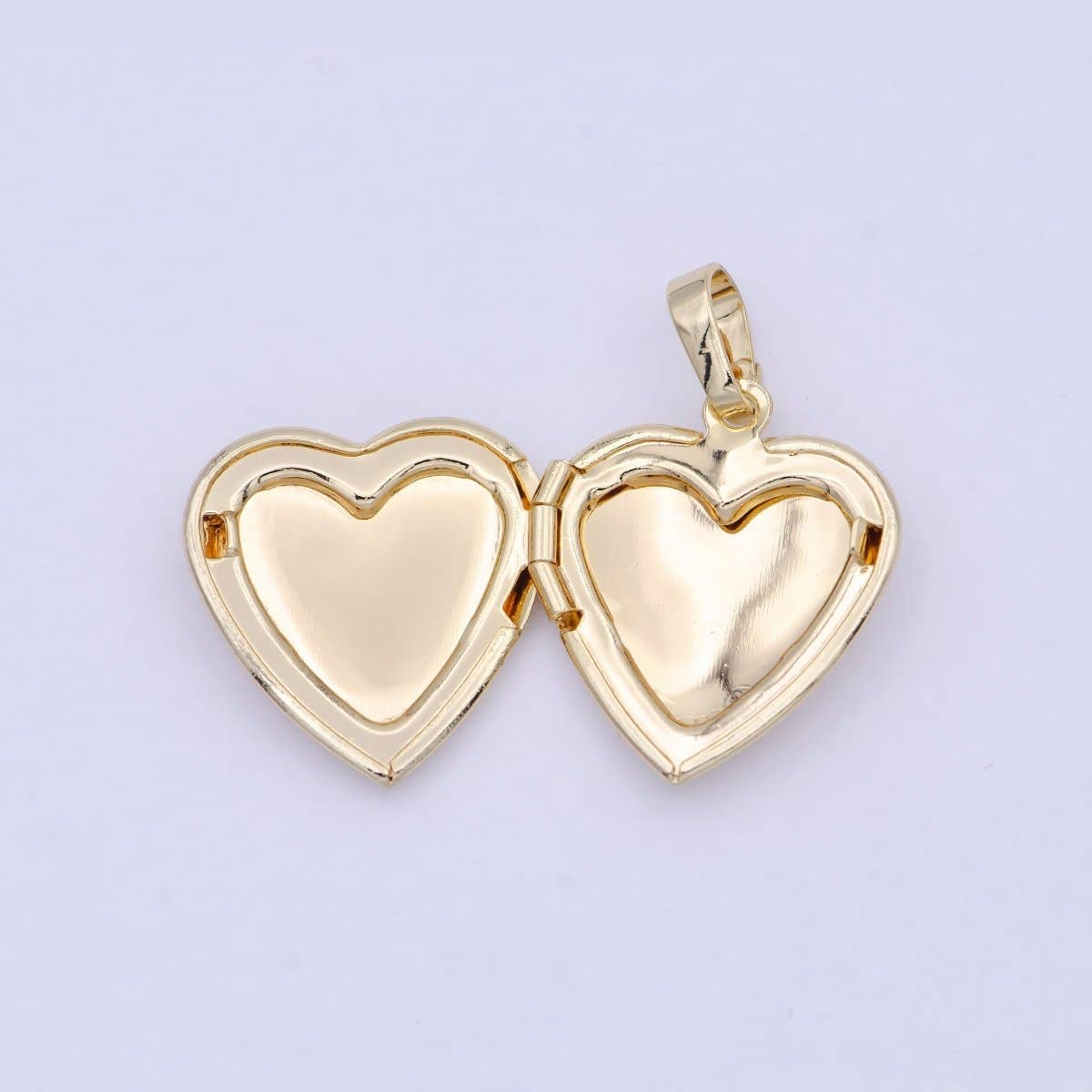 Tiny treasure chest for your heart! This 16K gold filled locket features a delicate heart shape and swings open to hold your most precious memories—a photo, a note, or whatever makes you smile. Crafted in gold-filled brass and completely lead and nickel-free, it's the perfect companion for everyday wear or a meaningful gift. At just 29mm, it's small enough to tuck close but mighty enough to spark joy.