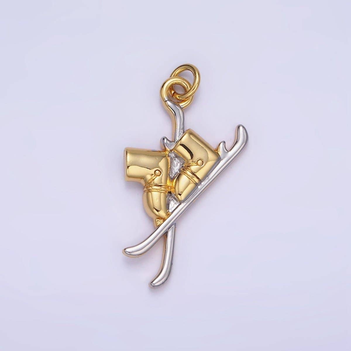 Hit the slopes in style with our Silver & Gold Ski Charm. This dual-toned treasure captures the thrill of the mountain in a miniature, high-detail design featuring a pair of classic skis with mounted boots.