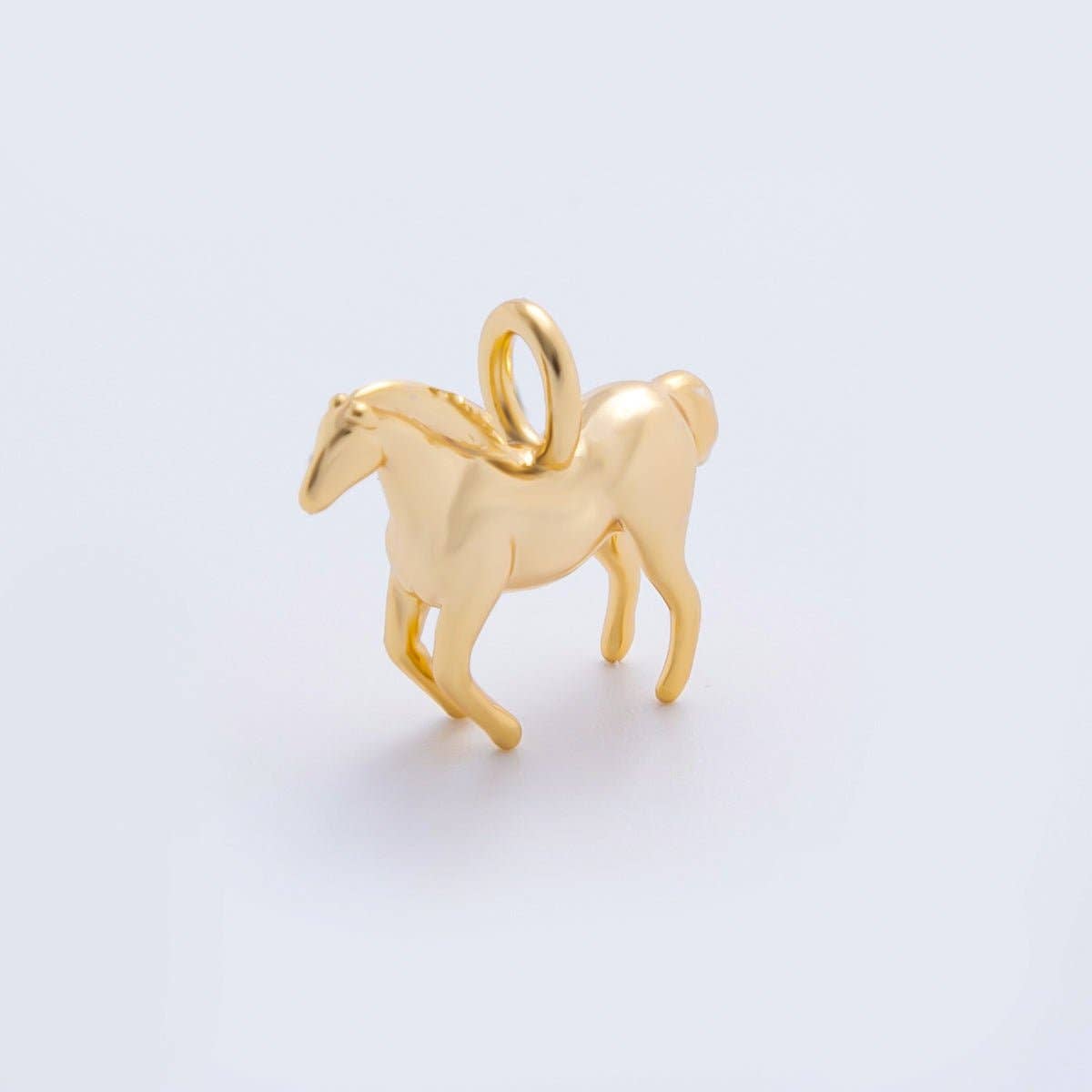 Capture the spirit of the open range with our Mini Gold Horse Charm. This gracefully detailed piece features a classic equestrian silhouette, making it a must-have for horse lovers, riders, and free spirits alike.
