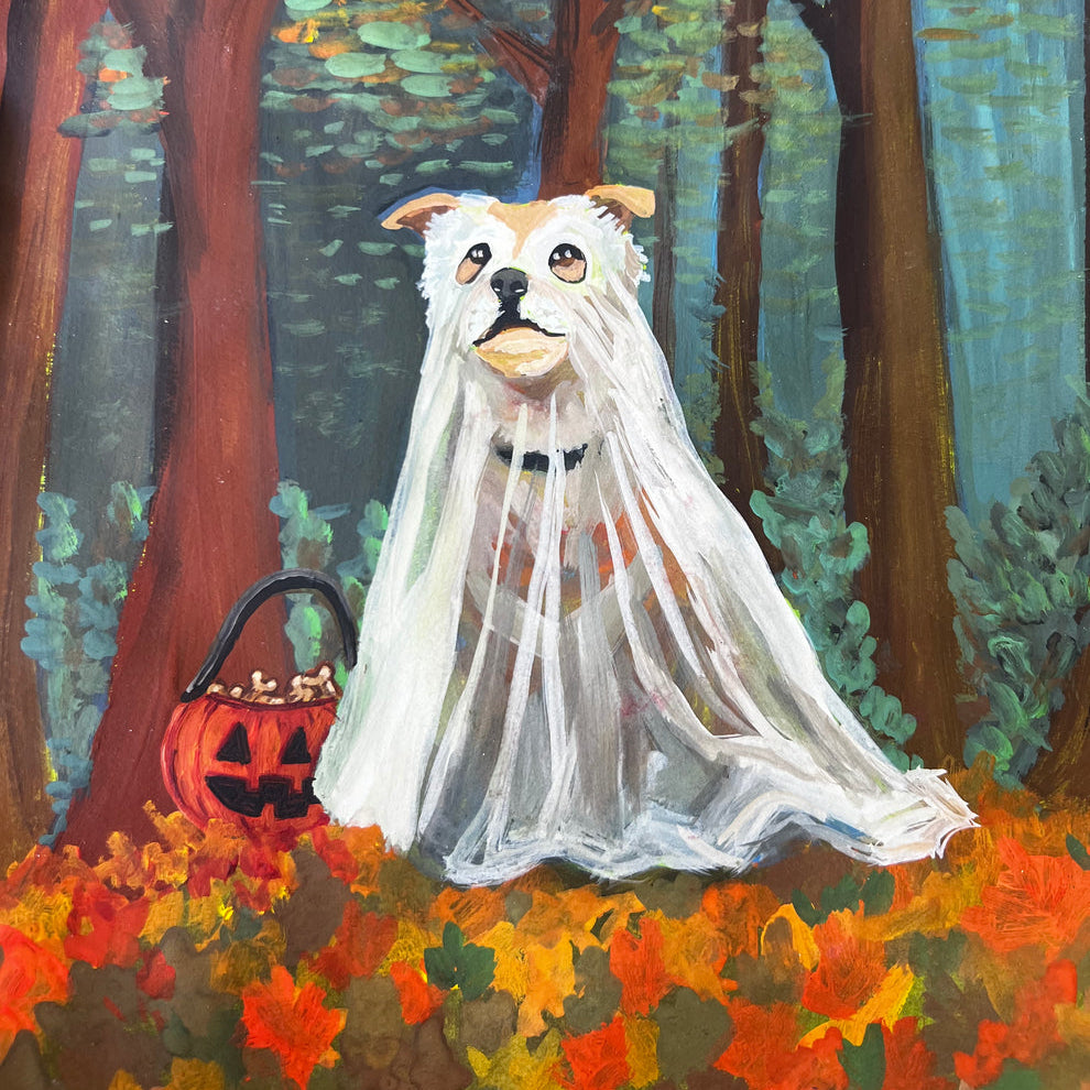 A whimsical painting depicts a white dog dressed as a ghost in a flowing white sheet, sitting in a colorful autumn forest with fallen leaves in shades of red, orange, and yellow. Beside the dog is a carved jack-o'-lantern basket filled with treats, set against tall trees with dappled light filtering through the canopy.