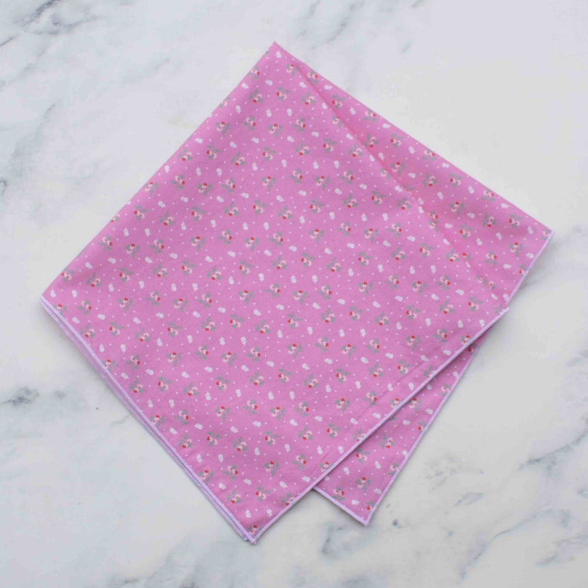 Sweet and subtle, the Mini Rosebud square scarf brings a soft vintage charm to your style. Made from 100% lightweight cotton and measuring approximately 17 inches, it features an all-over petite rose pattern on either a crisp white or playful pink background. Finished with fine stitched edges, it’s perfect for tying around your neck, wrist, or bag for a gentle, romantic touch.