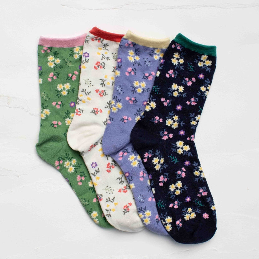 Add a fresh touch of charm to everyday outfits with these delicate wildflower pattern socks. Featuring a scattered floral design inspired by blooming spring gardens, these socks bring soft color and playful elegance to any look. The breathable cotton blend provides all-day comfort while maintaining shape and stretch. Perfect for casual wear, gifting, or adding a subtle floral accent to your wardrobe. Available in multiple soft seasonal colorways. Soft, breathable cotton blend Comfortable stretch fit.