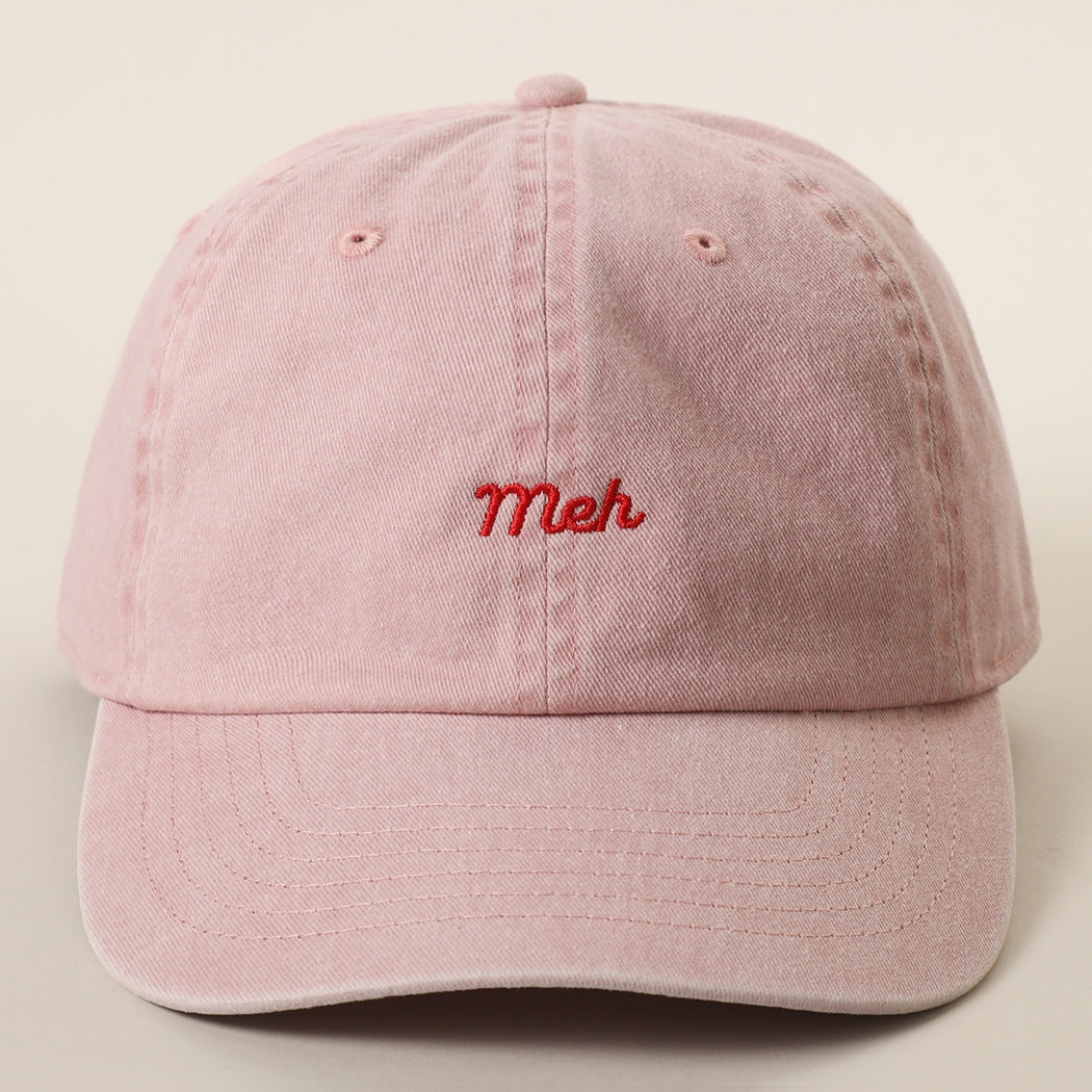 This embroidered design features the word “meh” in clean, minimal lettering, expressing a laid-back, indifferent attitude with subtle humor. The embroidered text adds texture and dimension, giving the design a polished, modern appearance. Simple yet expressive, it offers effortless everyday style with a relaxed and understated personality. This 6-panel cotton baseball cap offers a relaxed fit and a naturally curved brim for a comfortable, everyday look. Made of 100% cotton, it provides breathability.