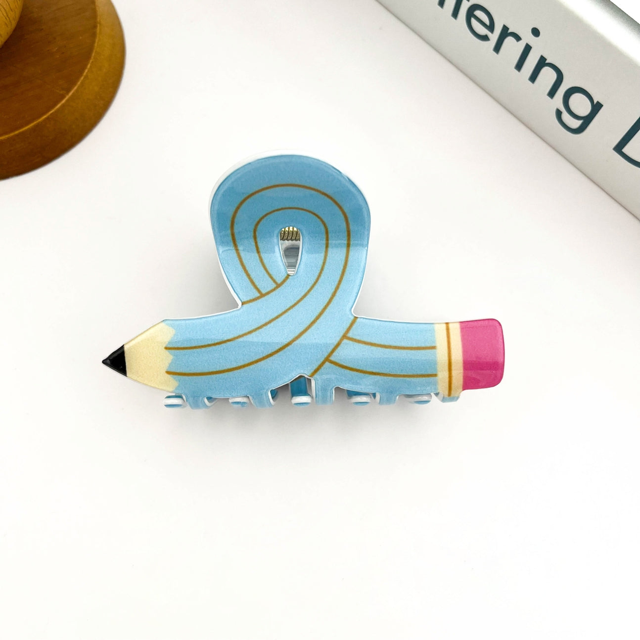 Add a creative twist to your hairstyle with this Cartoon Pencil Hair Claw Clip, designed to look like a fun and colorful pencil! With its quirky, school-inspired shape and bold cartoon detailing, this clip brings a touch of whimsy to your everyday look. Made from sturdy, lightweight material with a strong grip, it’s perfect for holding hair in place while expressing your playful personality. Great for students, teachers, or anyone who loves unique, conversation-starting accessories!