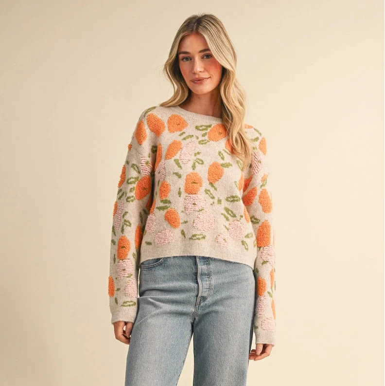 Wrap yourself in cozy comfort with this charming Fuzzy Texture Floral Knit Sweater. Crafted in warm oranges and creams, the delicate floral design brings a touch of nature-inspired elegance to your everyday wardrobe. The soft, fuzzy knit feels gentle against your skin, while the relaxed fit and drop shoulder sleeves offer effortless style and ease of movement. Perfect for layering on cool days or wearing solo, this sweater is your go-to piece for looking put-together while feeling wrapped in warmth.