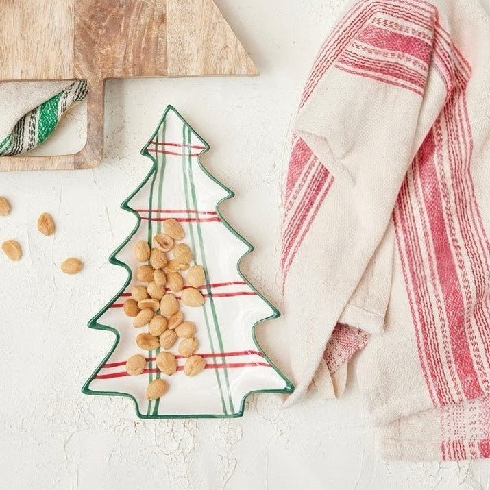 Bring festive warmth and cheerful holiday charm to your table with this lovely hand-painted ceramic tree-shaped plate. Featuring playful and whimsical holiday plaid, these charming plates are perfect for serving sweet treats, appetizers, or festive holiday bites to family and guests alike.