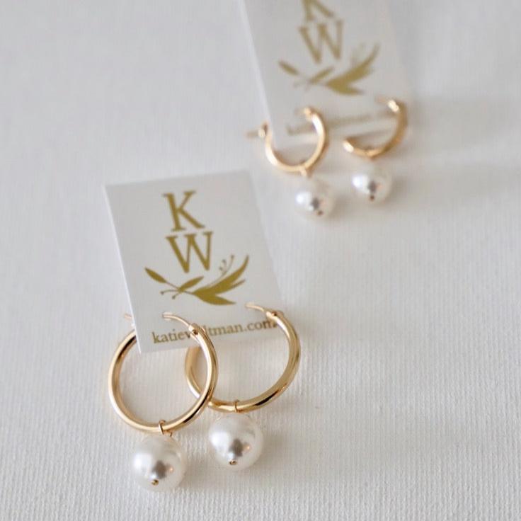 Add a touch of elegance with our Audrey Pearl Hoop Earrings. These stylish hoops feature delicate pearls for a classy yet playful look. Perfect for any occasion, these earrings are sure to add a touch of charm to any outfit.
