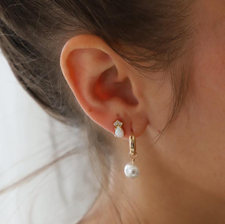 Add a touch of elegance with our Audrey Pearl Hoop Earrings. These stylish hoops feature delicate pearls for a classy yet playful look. Perfect for any occasion, these earrings are sure to add a touch of charm to any outfit.
