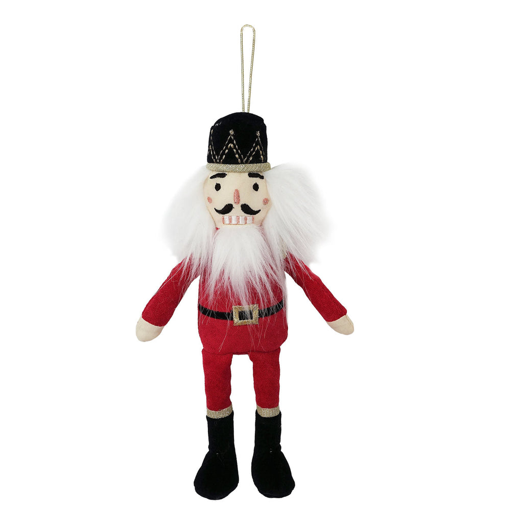 Hang on trees, wreaths and even chandeliers, our Nutcracker Plush Doll Ornament brings a new kind of whimsy to your seasonal decor.  Made of polyester and metallic thread. Measures 10" Each ornament is stitched with intricate embroidery, stitching and multiple fabrics and textures to bring these plush dolls to life. Hangs from a metallic loop. Spot clean only For decorative use only, not a toy