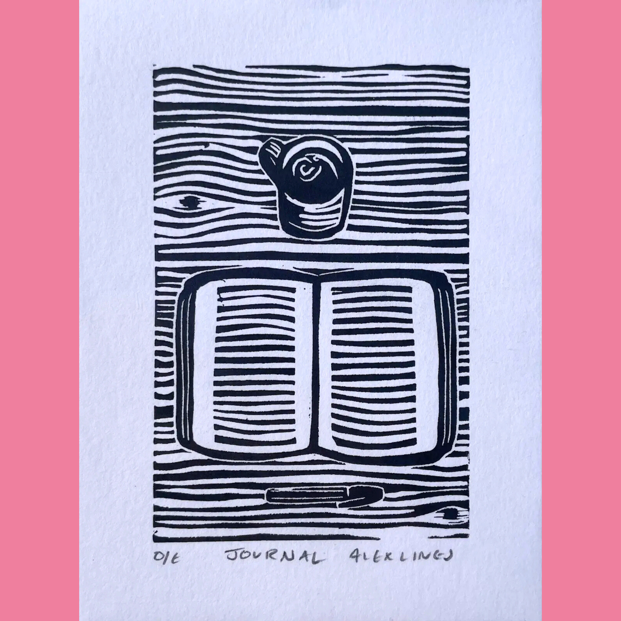 A black-and-white linocut print illustrates an open journal with lined pages, resting on a textured wooden surface depicted with wavy horizontal lines, while a simple coffee mug sits atop the book and a pen lies at the bottom edge. The artwork is printed on white paper with the title "JOURNAL," the number "01E," and the signature "ALEX LINES" written below, surrounded by a bright pink border.